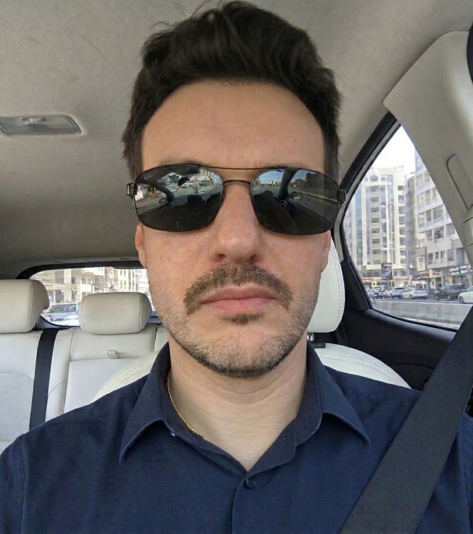 Raphael Bohrer wearing sunglasses in a car selfie